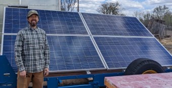 Volunteer Brian Naughton in front of the RGCF Solar Trailer